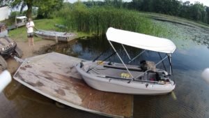 pontoon with lake mower mounted in back